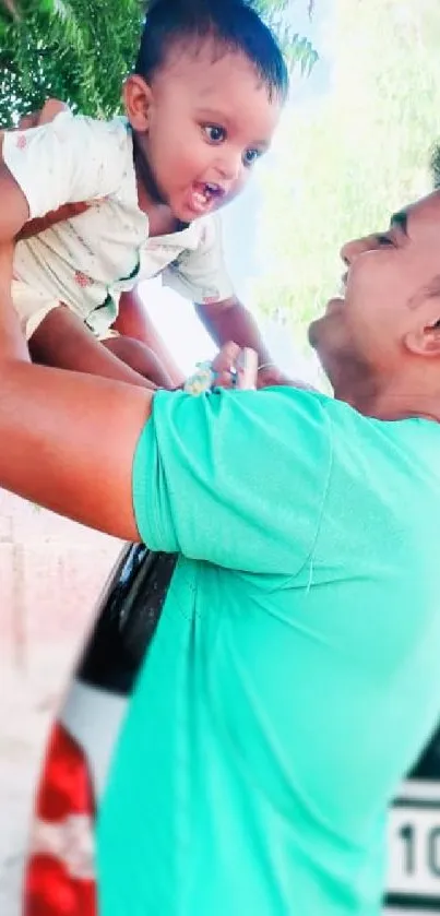 Father joyfully lifts child, under green leaves.