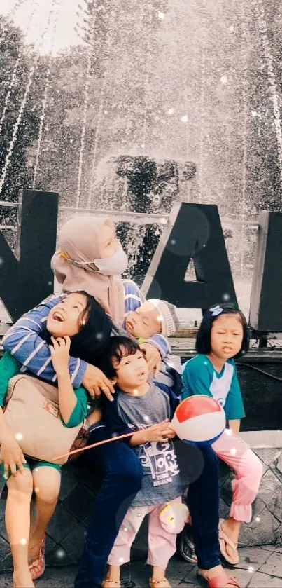 Children posing by a large fountain with a relaxing atmosphere.