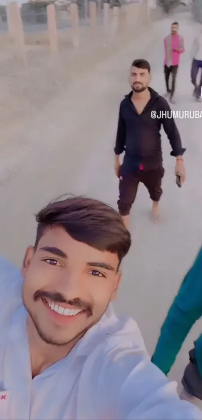 Group of friends joyfully taking a selfie on a sunny walk.