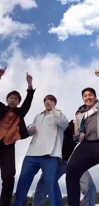 Group of friends posing joyfully under a bright blue sky.