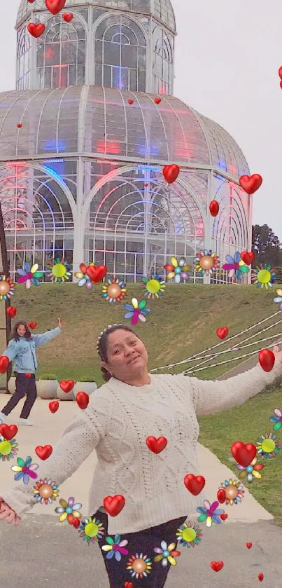 Person with floral heart frame at glass conservatory.