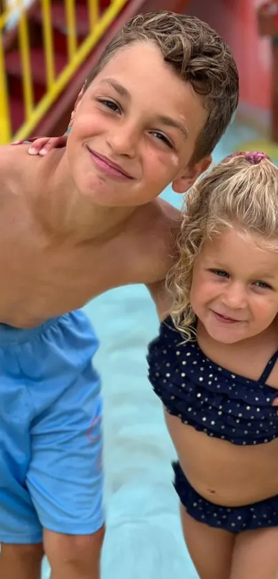 Two smiling kids in swimwear enjoying the pool on a sunny day.