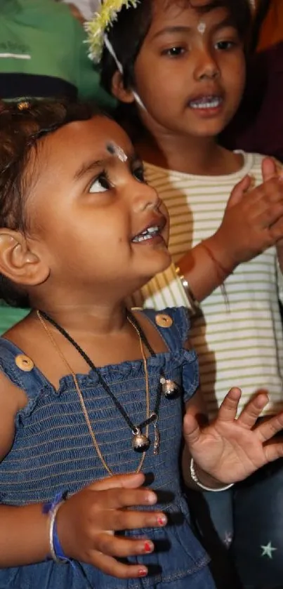 Joyful kids engaged in playful clapping, exuding happiness.