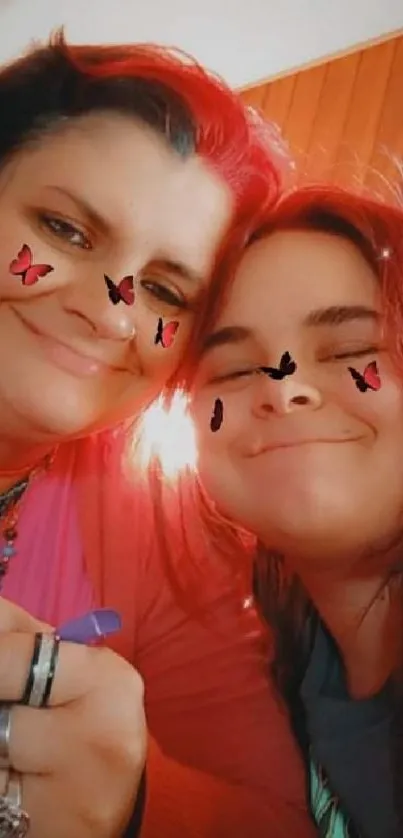 Mother and daughter smiling with butterfly stickers on faces.