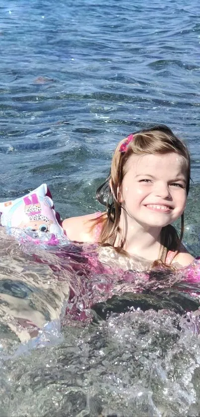 Girl smiles while playing in ocean waves on a sunny beach day.