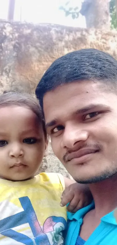 Father and child smiling in outdoor portrait.