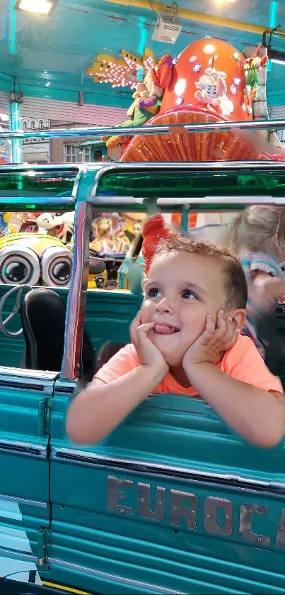 Boy enjoys a colorful ride at the funfair with vibrant teal surroundings.