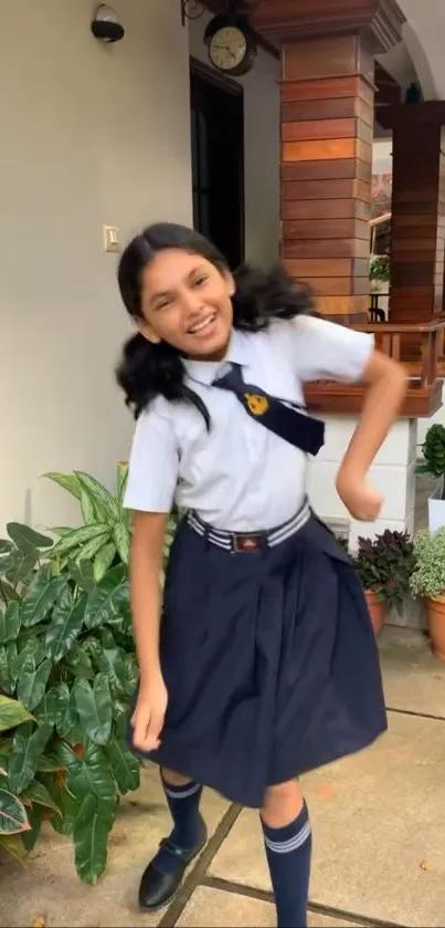 A joyful schoolgirl in uniform dances happily in a lush garden setting.