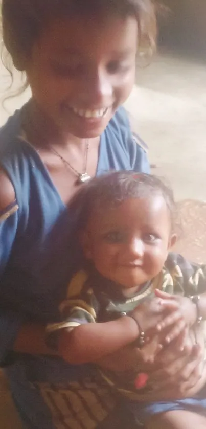 Smiling sister holding baby sibling indoors.