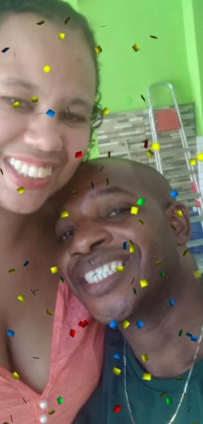 Smiling couple with colorful confetti background.