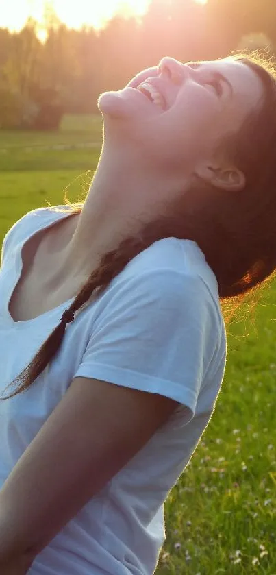 Smiling woman enjoying the sun in a green field.