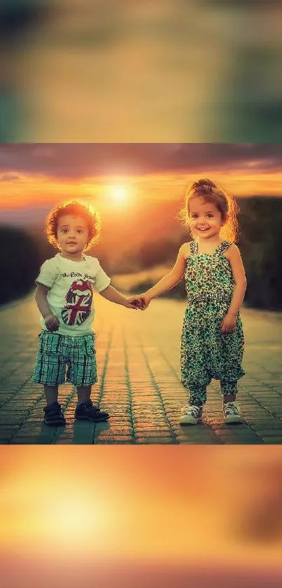 Two kids holding hands at sunset, smiling in a scenic outdoor pathway.