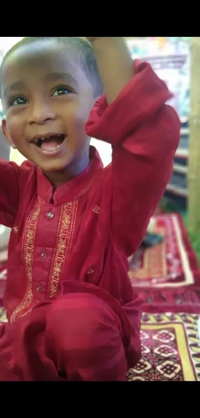 Joyful toddler in vibrant red attire, radiating happiness.