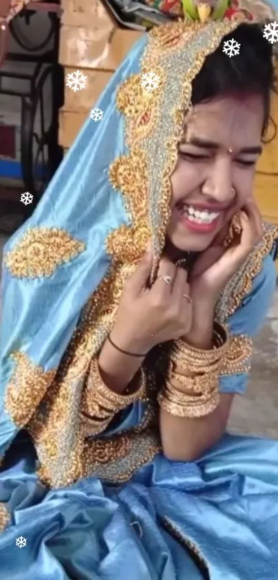 Smiling woman in blue traditional clothing with gold details.