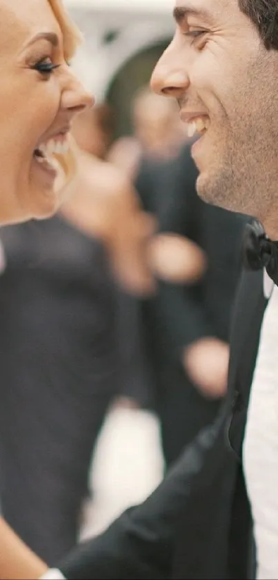 A joyful bride and groom laughing on their wedding day.