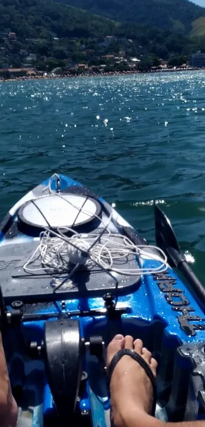 Kayaking adventure on sparkling blue waters with misty mountains.