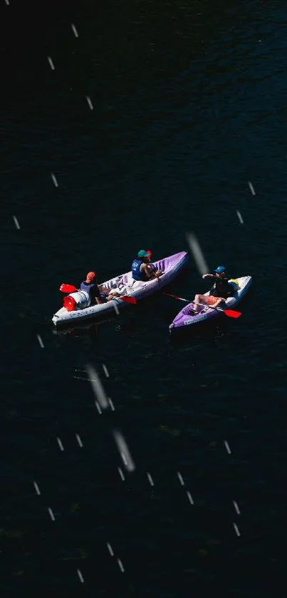 Three kayakers paddling on dark blue water.