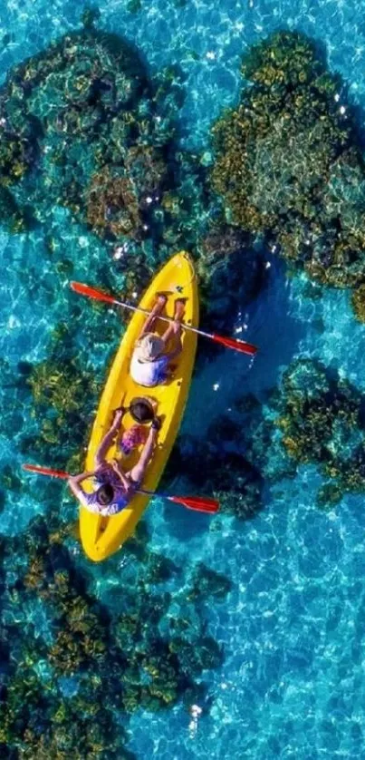 Aerial view of a kayak on clear blue ocean with coral reefs.