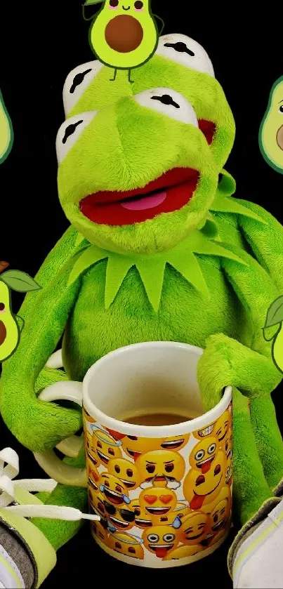 Kermit holding avocado-themed mug with emojis.