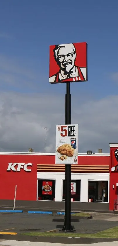KFC restaurant with logo under a clear blue sky, palm trees in the background.