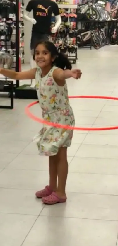 Child joyfully hula hooping indoors.