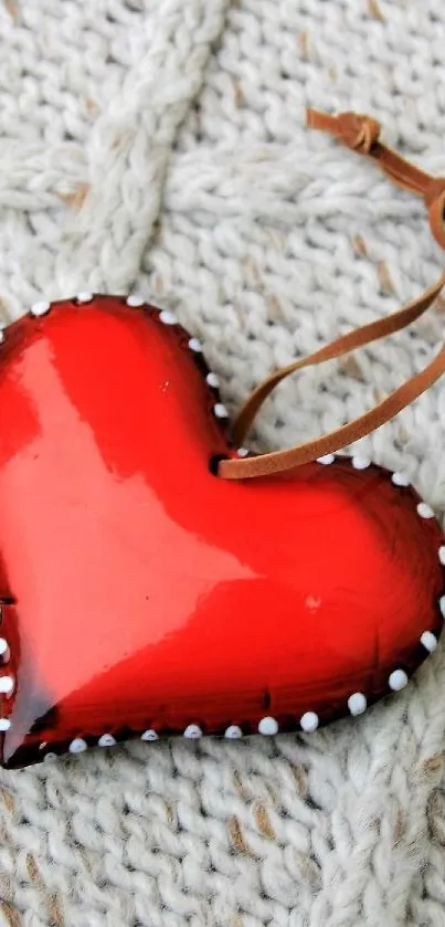 Red heart on a knitted fabric background.
