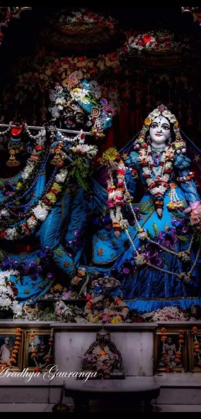 Krishna and Radha in blue attire framed by floral garlands and intricate patterns.