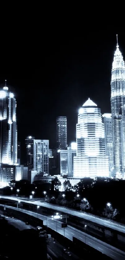 Kuala Lumpur city skyline at night featuring Petronas Towers in black and white.