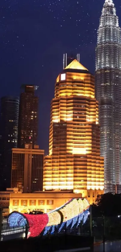 Kuala Lumpur's Petronas Towers illuminated at night under a starry sky.