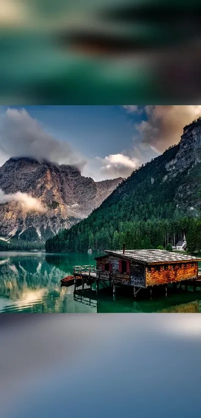 Breathtaking lakeside view with mountains and cabin.