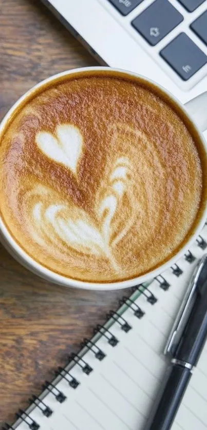 Latte art on coffee with notebook and pen on a wooden desk.