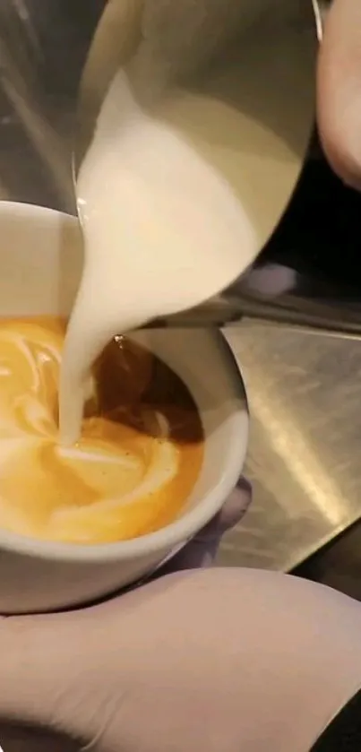 Close-up of milk being poured into espresso, creating latte art.