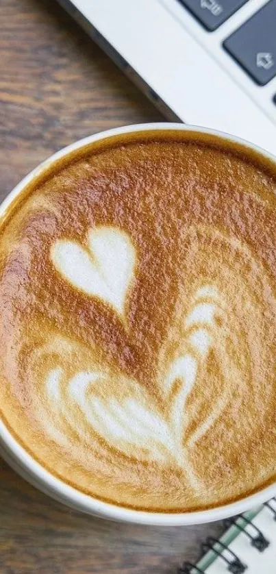 Heart-shaped latte art with keyboard background on wallpaper.