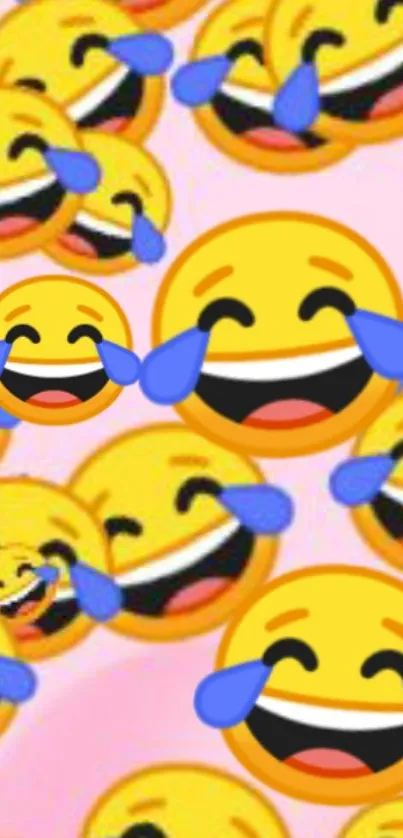 Mobile wallpaper with laughing emojis on pink background.