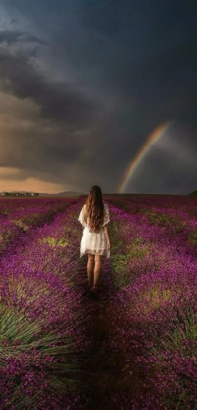 A woman walks in a lavender field under a rainbow-filled sky.