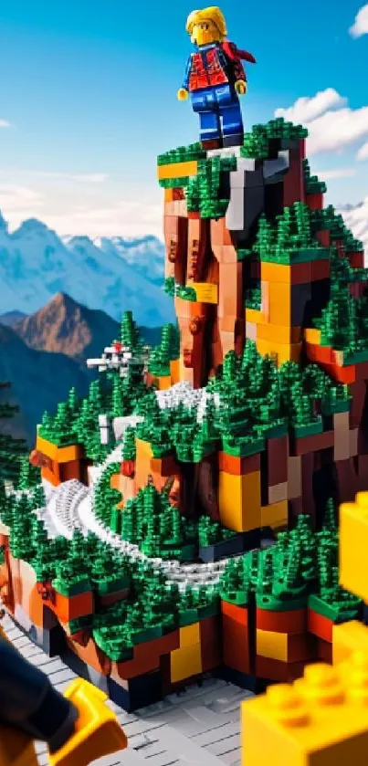 LEGO brick mountain with figures and scenic backdrop.