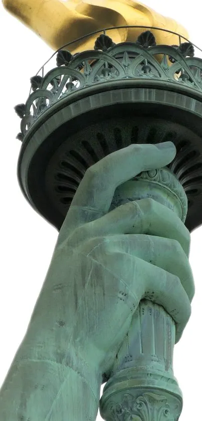 Close-up of Statue of Liberty torch against white background.