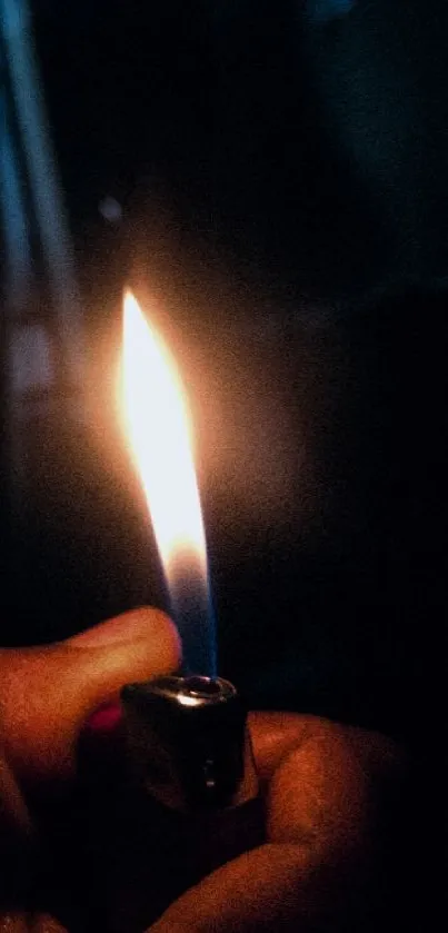 Hand holding a lit lighter in darkness, creating a striking contrast.