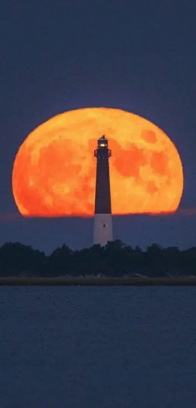 Lighthouse silhouette with vibrant full moon in the background.