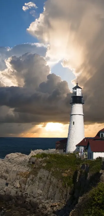 Lighthouse with dramatic sunset and clouds over ocean coast.