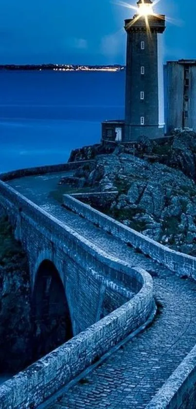 Serene dusk view of a lighthouse by the sea on coastal rocks.