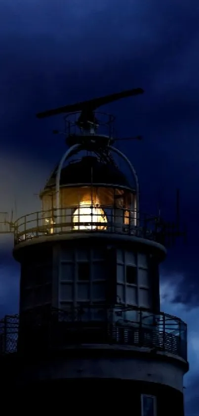 Lighthouse in dark night with stormy sky and beam of light.