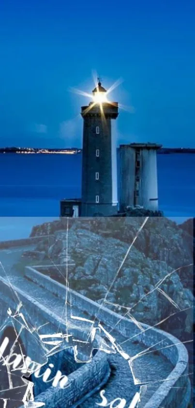 Majestic lighthouse on rocky shore at night with vibrant blue ocean and sky.