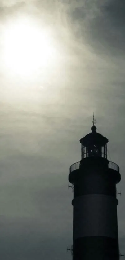 Lighthouse silhouette with a dramatic sky background.