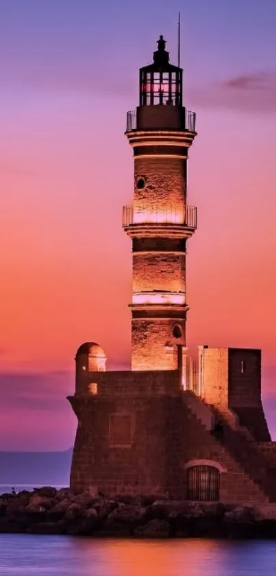 Beautiful lighthouse silhouetted against a vibrant purple and orange sunset.