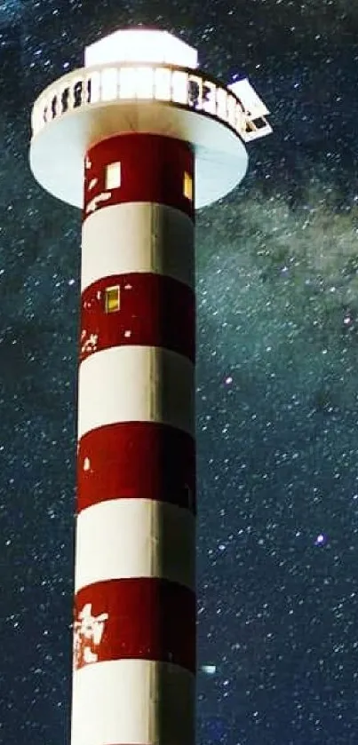 Red and white lighthouse under a navy starry sky.