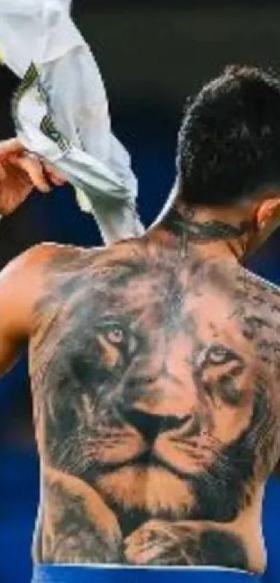 Close-up of a lion tattoo on a person's back, showcasing intricate design and artistry.