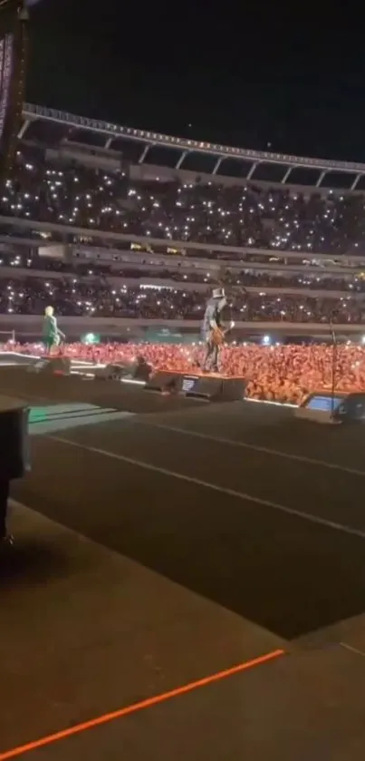 Vibrant live concert with energetic crowd under stadium lights.