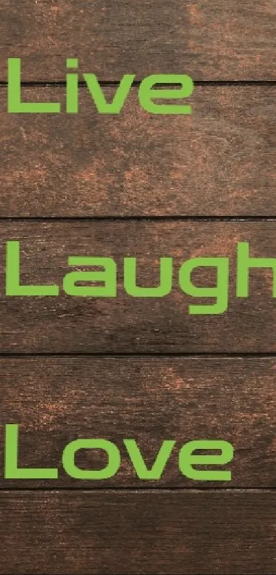 Live Laugh Love quote on wooden background with gift boxes.