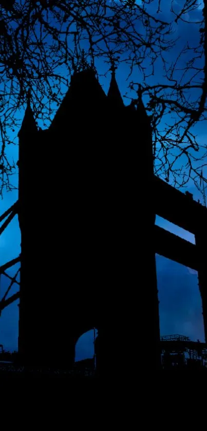 London Tower Bridge silhouette at night with dark blue sky.